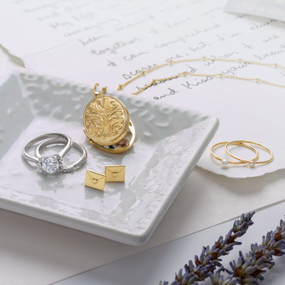Gold Jewellery with a 14K White Gold Diamond Engagement ring with matching diamond wedding band. A Large 14K Gold Locket and Beaded Chain, and a pair of envelope 14K Gold Earrings Studs, with two pearl stackable rings.