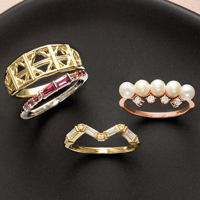 Four gold rings. 1. A metal fashion gold ring. 2. Baguette rubies, white gold. 3. Pearl & Diamond Rose gold ring. 4. Baguettes & Round diamonds yellow gold ring. Available Online from Jewels of St Leon Australia.