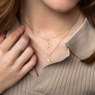 Necklaces for Women Australia - Stylish woman wearing two heart pendant necklaces, layering them for a chic and trendy look. Perfect accessories for any occasion.