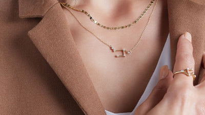 Model showcasing Jewels of St Leon's stunning women's yellow gold collection, adorned with a radiant diamond necklace and elegant chain. Elevate your style with our exquisite pieces today!