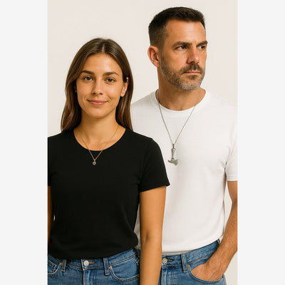 A female model wearing a black t-shirt and a pink cz heart pendant gold-plated necklace, and a male model wearing a stainless steel silver axe necklace.