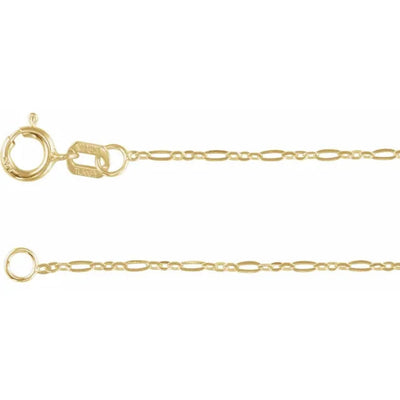 Close-up of the spring-ring clasp and attached tag stamped “14K,” linked to the 1.25 mm solid 14 kt yellow gold Figaro chain, showcasing the hallmark and precision craftsmanship.