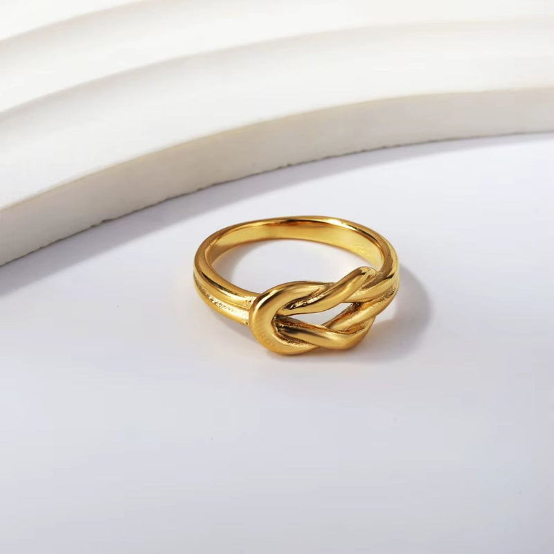 A delicate 18K gold-plated stainless steel Love Knot Ring with an intricate knot design. A meaningful jewellery piece symbolising love and connection.