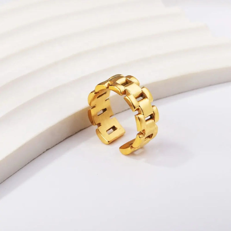 A contemporary 18K gold-plated stainless steel bracelet-style ring with an 8mm width. A stylish and versatile modern gold ring.