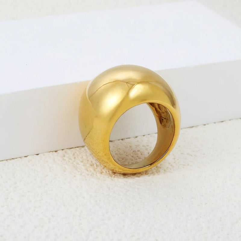 The bold 22mm width creates a statement piece that exudes elegance and confidence. A luxurious 18K gold-plated stainless steel dome ring with a high-shine, smooth surface.