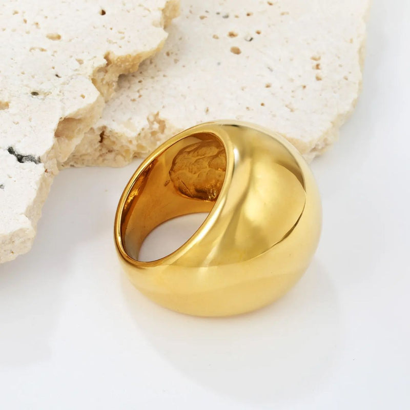 A luxurious 18K gold-plated stainless steel dome ring with a high-shine, smooth surface. The bold 22mm width creates a statement piece that exudes elegance and confidence.