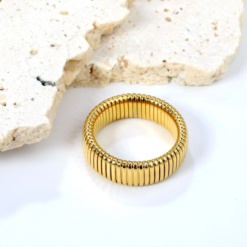 A sleek 18K gold-plated stainless steel 7mm stackable band with a polished finish. A versatile, everyday essential for ring stacking.