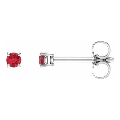 This stunning photo captures a 2.5mm natural ruby in a 4-prong setting made from lustrous 14kt white gold. The front and side angles showcase the exquisite craftsmanship and the ruby's captivating beauty. Shop women's ruby earrings from Jewels of St Leon.