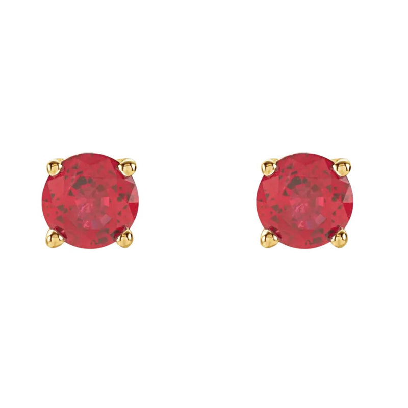 Behold the allure of our 4mm natural ruby earring studs in a four prong setting, expertly fashioned from 14kt yellow gold. The front-facing image highlights the radiant splendour of the medium dark red natural rubies, making a captivating statement. Shop ruby stud earrings from Jewels of St Leon.