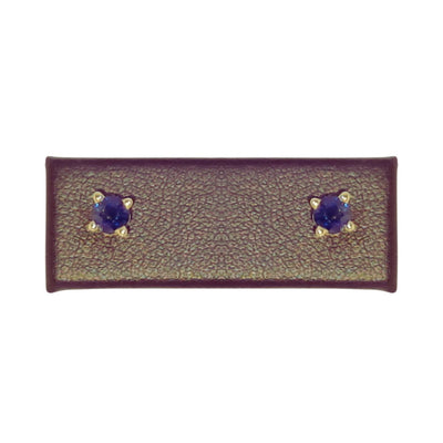 A stunning close-up of 4mm Natural Blue Sapphire Earrings set in 14K Yellow Gold, showcasing their vivid hue and classic elegance. These studs add a sophisticated sparkle to any outfit. Available at Jewels of St Leon. Shop now.