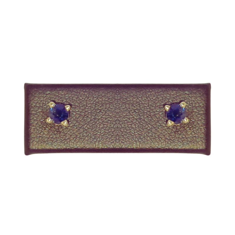 A stunning close-up of 4mm Natural Blue Sapphire Earrings set in 14K Yellow Gold, showcasing their vivid hue and classic elegance. These studs add a sophisticated sparkle to any outfit. Available at Jewels of St Leon. Shop now.
