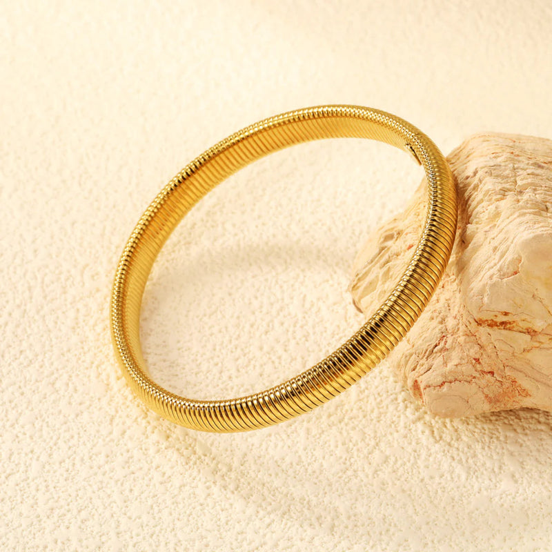8mm Flexible Snake Bracelet, showcasing its seamless design and high-shine gold finish.