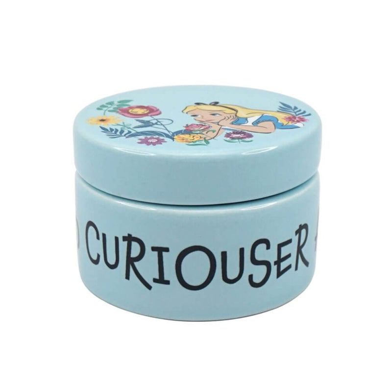 A front view showcasing the intricately illustrated lid featuring Alice with the talking flowers, and the side of the box with "Curiouser and Curiouser" in elegant blue.