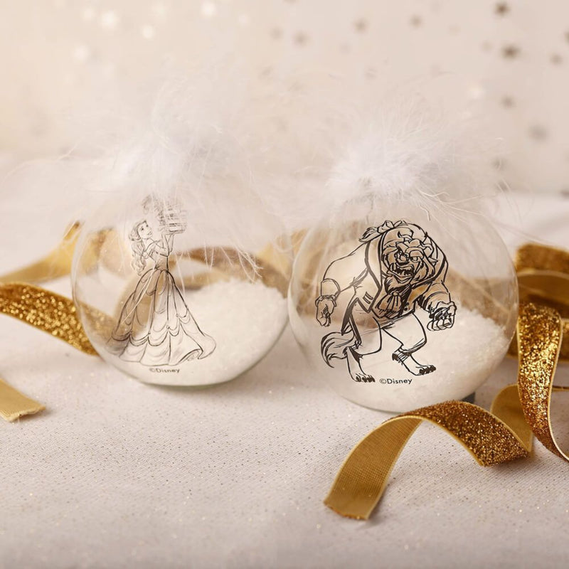 Beauty and the Beast collectible Christmas bauble set with Belle and Beast designs, displayed with gold ribbon and feather accents.