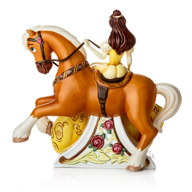 The figurine portrays Belle in her classic yellow gown, perched on her loyal companion, Phillipe. The dress is decorated with hand-painted roses, and Phillipe is crafted perfectly to show off the strong stature of its Belgium Draft breed.