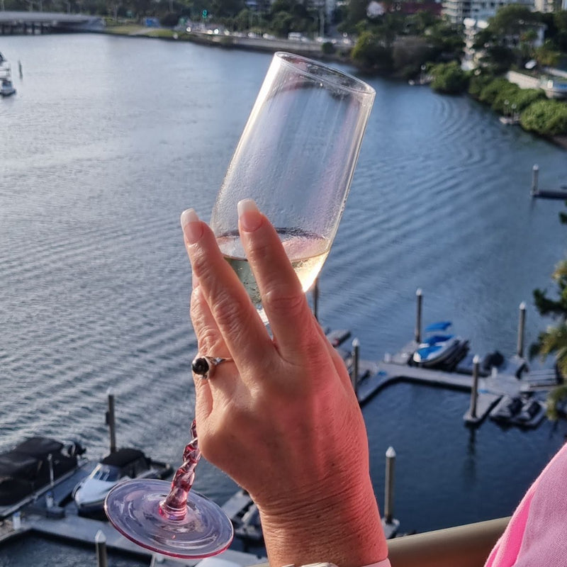 Black Akoya Cultured Pearl and Diamond Ring crafted from 14kt White Gold on the hand of a model, with the Gold Coast River in the background. Available from Jewels of St Leon.