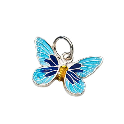 A stunning close-up of the Blue Enamel Butterfly Charm Pendant, showcasing its intricate detailing in light blue, dark blue, and gold on sterling silver.