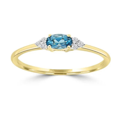 9ct Yellow Gold Ring with oval blue topaz and 0.03ct diamonds. Available from Jewels of St Leon.