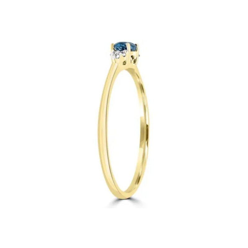 Side View of 9ct Yellow Gold Ring with oval blue topaz and 0.03ct diamonds. Available from Jewels of St Leon.