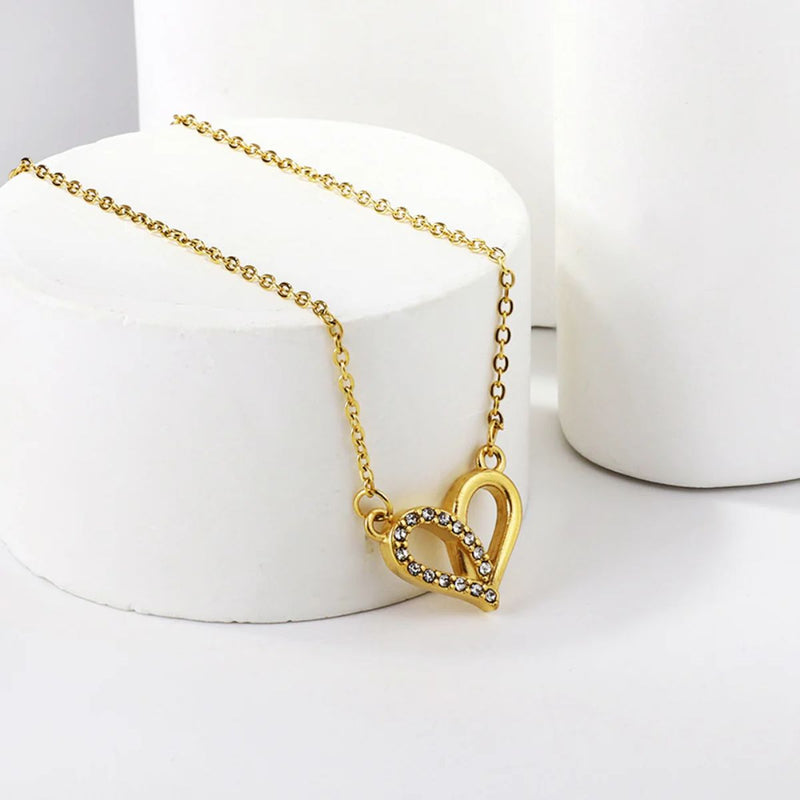 Heart Necklace hanging down a round display, highlighting the CZ accents, romantic shape and golden shine — perfect for gifting.
