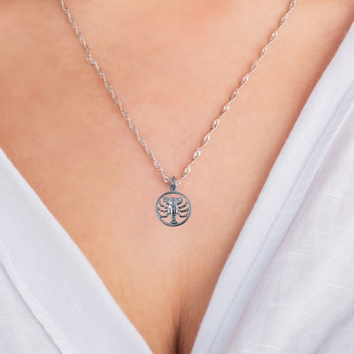 A model wearing the Cancer Zodiac Charm Pendant on a sterling silver chain, highlighting the charm's detailed craftsmanship and personalised design that complements any outfit with astrological meaning.