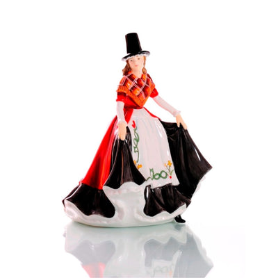 The Welsh Beauty Figurine from the Celtic Ladies Collection showcases a proud Welsh woman in national dress, featuring a black hat, red coat, and daffodil-adorned apron. Handcrafted from fine bone china. Available from Jewels of St Leon.