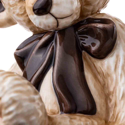 A detailed close-up of the oversized glossy bow tie, emphasizing its lustrous finish and precise hand-painted craftsmanship.