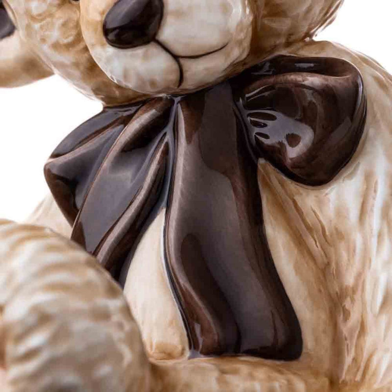 A detailed close-up of the oversized glossy bow tie, emphasizing its lustrous finish and precise hand-painted craftsmanship.