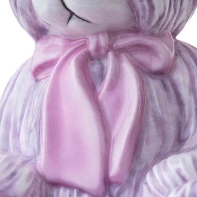 A detailed close-up of the satin pink bow, revealing the lifelike folds and shimmering finish that add a touch of elegance to this limited-edition masterpiece.