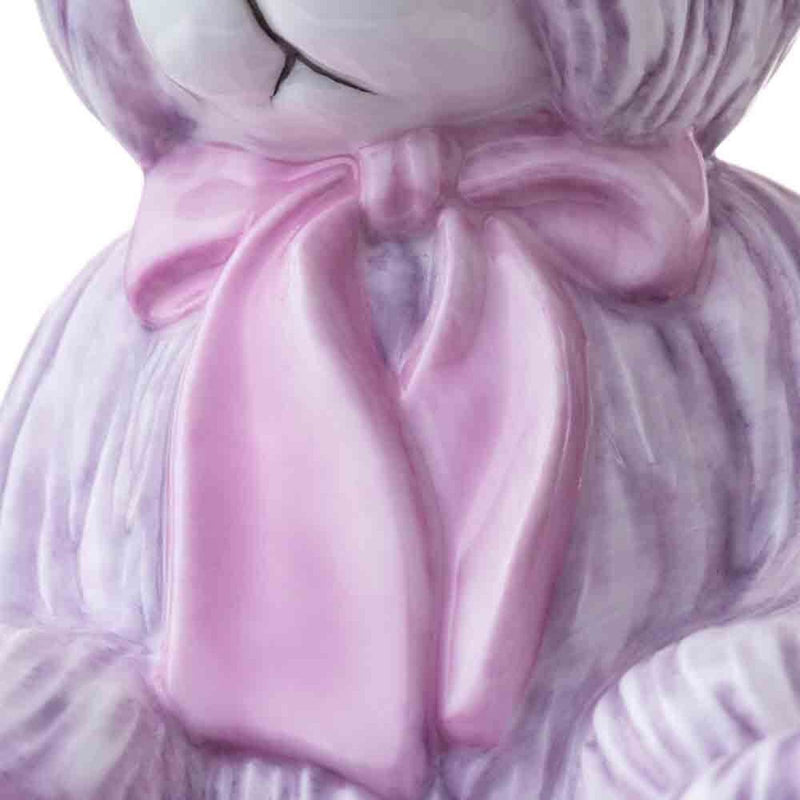 A detailed close-up of the satin pink bow, revealing the lifelike folds and shimmering finish that add a touch of elegance to this limited-edition masterpiece.