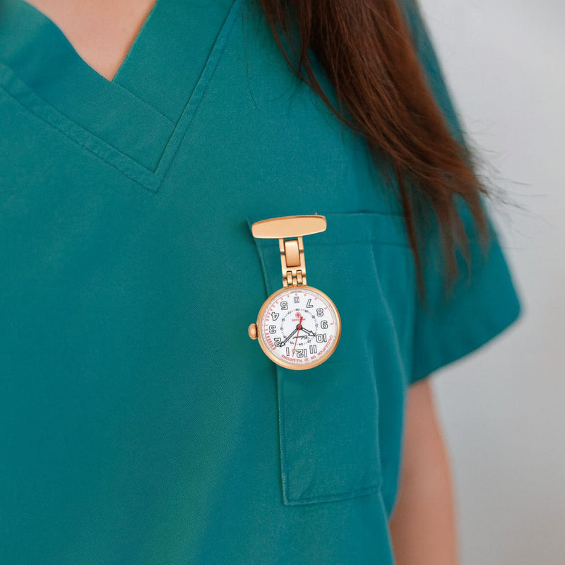 Classique Pro-Care Rose Gold Plated Nurses Watch pinned to nurse’s scrub top, showing white dial with black numerals.