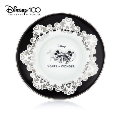 Mickey and Minnie Mouse - Disney 100 Cup and Saucer Set. This exquisite set features stunning imagery that celebrate 100 years of Disney magic. Handmade and hand decorated, this set is made from fine bone china and finished with real platinum decoration. Shop now at Jewels of St Leon.