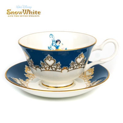 Indulge in the magical world of Disney with our exquisite Disney Princess - Snow White Cup and Saucer Set. Celebrating Walt Disney's first animated classic, Snow White and the 7 Dwarfs, this beautiful blue cup and saucer set is the perfect addition to your collection.  Hand-made and hand-decorated, this cup and saucer set is finished with genuine 22K gold, adding a touch of luxury to your tea time. Shop now at Jewels of St Leon Jewellery, Giftware and Watches.