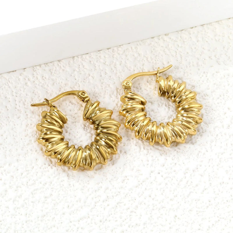 A stylish presentation of the chunky hoops against a soft neutral background, showcasing their bold and trendy design perfect for everyday glamour.