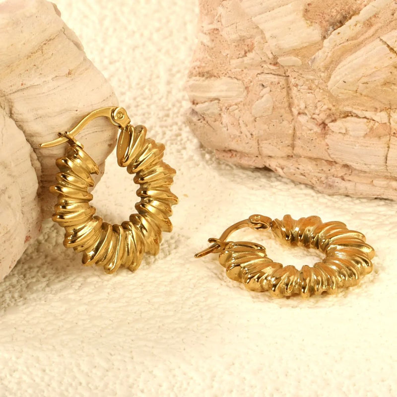 The Twisted Circle Hoops elegantly styled, demonstrating their versatile and eye-catching appeal for any outfit or occasion