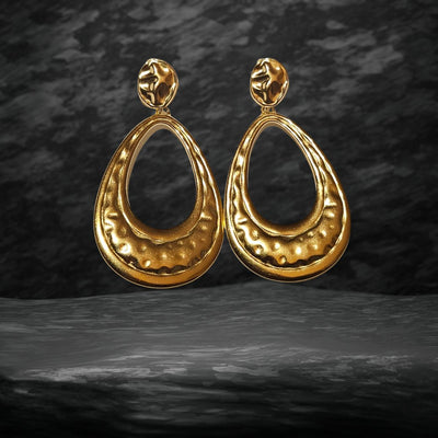 The Gold Oval Drop Earrings displayed on a marble surface, highlighting their lightweight design, long-lasting durability, and versatile appeal for all occasions.
