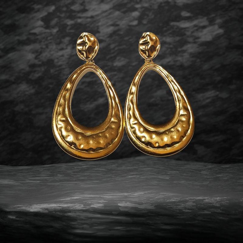 The Gold Oval Drop Earrings displayed on a marble surface, highlighting their lightweight design, long-lasting durability, and versatile appeal for all occasions.