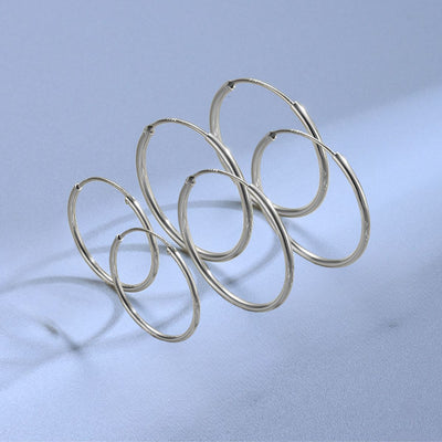 Sterling silver hinged endless hoop earrings in 40mm, 50mm and 60mm sizes displayed together