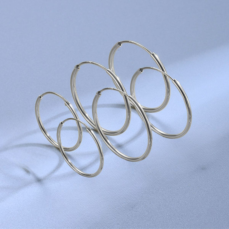 Sterling silver hinged endless hoop earrings in 40mm, 50mm and 60mm sizes displayed together