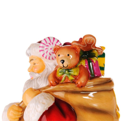 Father Christmas Figurine close-up showing teddy bear and sweets in gift sack