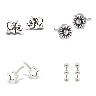 A display of all four sterling silver earrings in the set: Open Star, Lucky Elephant, Petite Flower, and Moving Triple Ball Dangle.