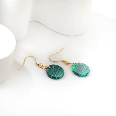 The Malachite Style Earrings beautifully displayed against a neutral background, highlighting their unique texture and luxurious gold accents.
