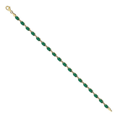 Introducing our exquisite Lab-Created Emerald Bracelet, a radiant tribute to May's birthstone. Crafted in luxurious 14kt yellow gold, this bracelet boasts timeless elegance and sophistication. Measuring 18cm long and secured with a lobster clasp, it offers both style and security for everyday wear. Adorned with 18 6x4mm oval lab-grown emeralds, each stone is meticulously set to showcase its vibrant green hue and beauty.
