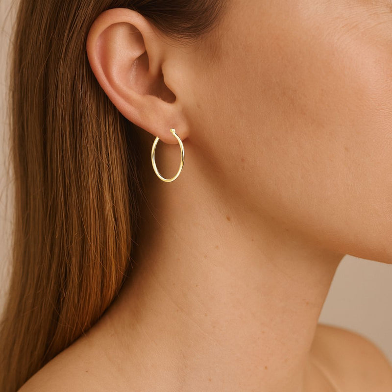 Model wearing 14ct Gold Plated Sterling Silver 20mm x 2mm Hoop Earrings