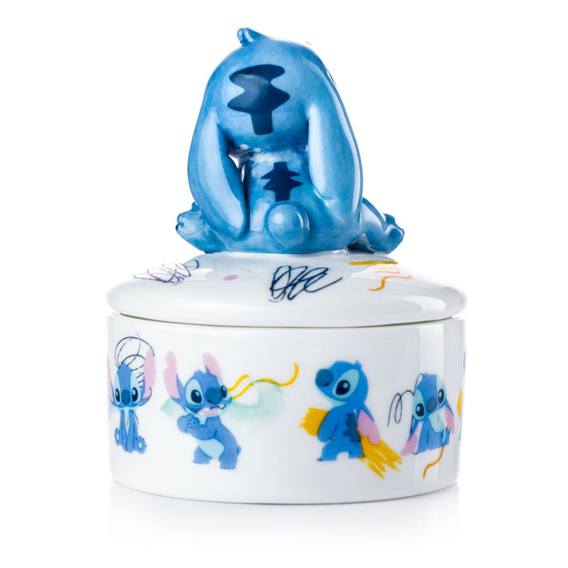 Stitch Mini Treasure Box! This beautiful trinket box is handmade and decorated using fine bone china, making it a genuinely collectable piece. The box is adorned with imagery of Stitch throughout, making it a must-have for any Lilo and Stitch enthusiast.  The best part is that this mini treasure box has a stunning handmade Stitch sitting on top, which you can use to open the box and reveal a surprise image of Stitch on the bottom of the piece.