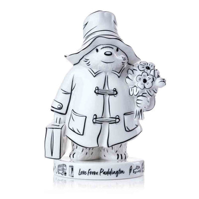 The "Love from Paddington" figurine is a stunning black-and-white sketch-style piece, showcasing Paddington in his iconic pose. With intricate illustration-like details, his classic blue coat, red hat, and suitcase are rendered in monochromatic tones, giving it an elegant, timeless appeal.