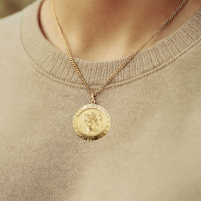 14kt Gold Filled necklace with a 25mm round St Christopher pendant Necklace worn by a female in a beige sweater.