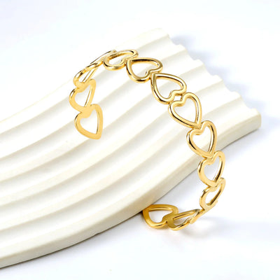 Close-up of the open heart cuff design, highlighting the smooth contours and refined detailing.