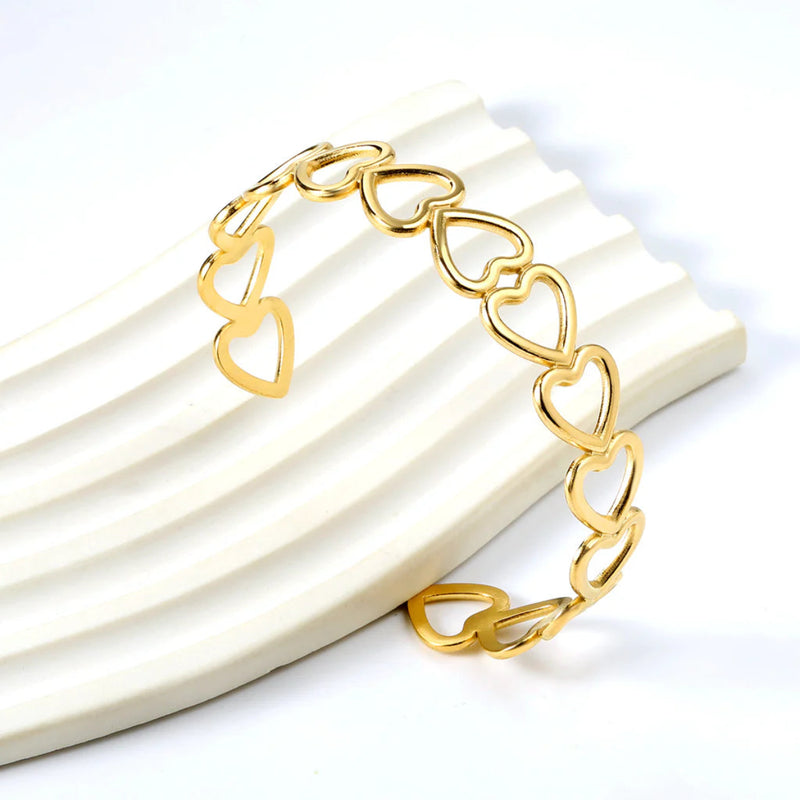Close-up of the open heart cuff design, highlighting the smooth contours and refined detailing.