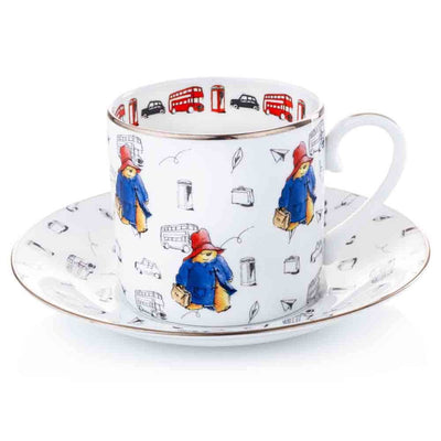 A stunning fine bone china cup and saucer featuring a vibrant Paddington in his classic red hat and blue coat. Iconic London motifs are detailed in a contemporary sketch style with pops of colour along the inner lip. Finished with a luxurious platinum trim.